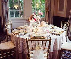golden chairs around a white table