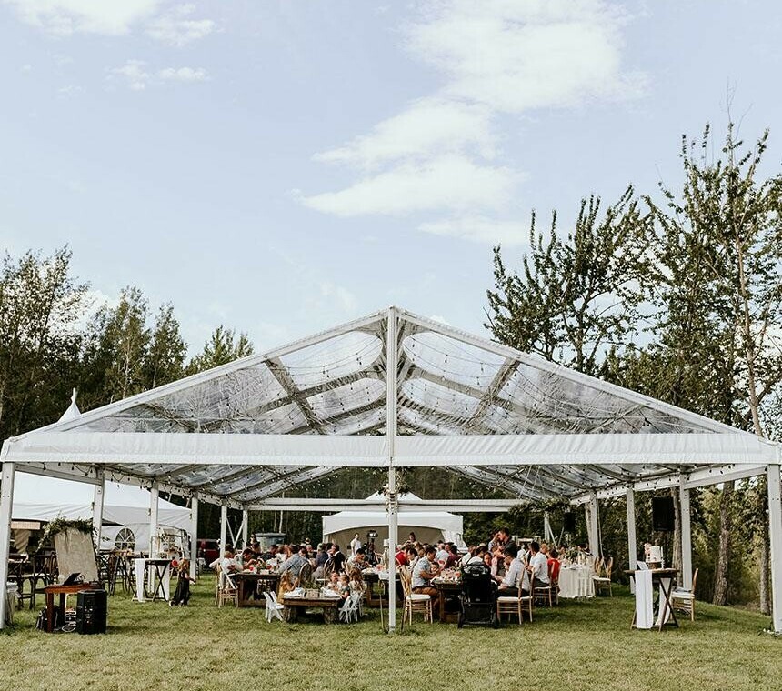 Tent Rentals Calgary featuring the front side of a clear top Clearspan A-Frame Tent covering a wedding reception